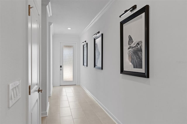 hall featuring light tile patterned flooring and ornamental molding