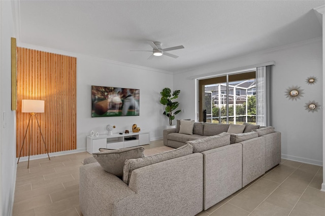 living room featuring light tile patterned floors, crown molding, and ceiling fan