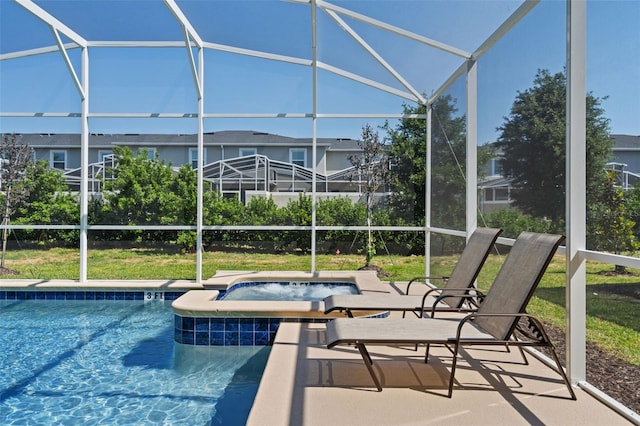 view of pool with a patio, a lanai, and a jacuzzi