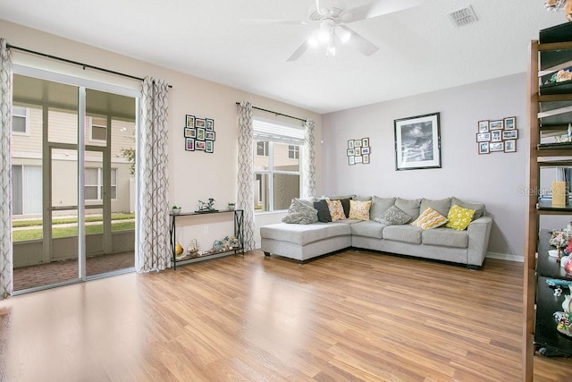 living room featuring ceiling fan and light hardwood / wood-style floors