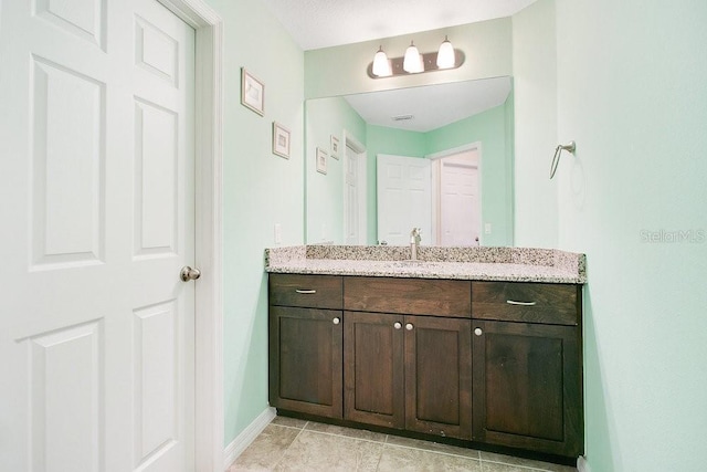 bathroom with tile patterned floors and vanity