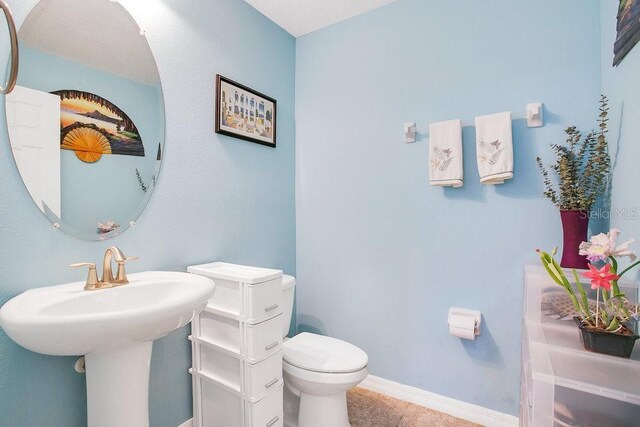 bathroom with tile patterned floors and toilet