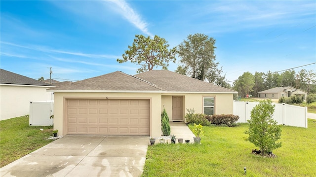 single story home featuring a garage and a front lawn