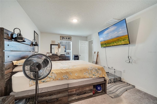 bedroom featuring a textured ceiling and carpet