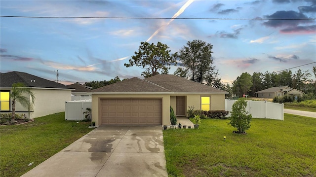 ranch-style house with a garage and a lawn