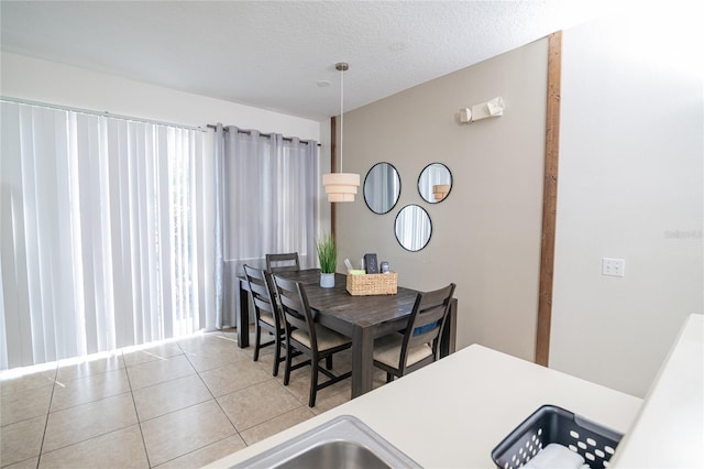 dining area with tile patterned floors and a textured ceiling