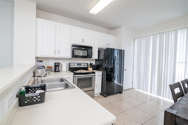 kitchen featuring sink, black appliances, white cabinets, and light tile patterned floors