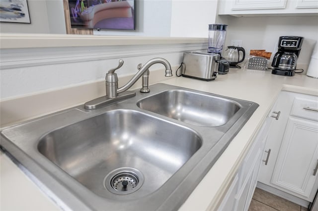 interior details with sink and white cabinets