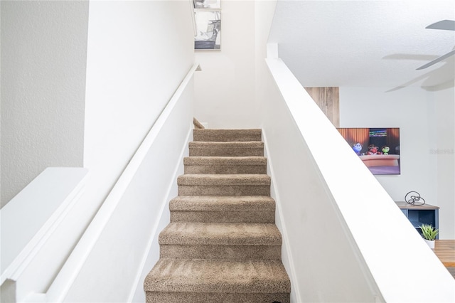 stairs with ceiling fan