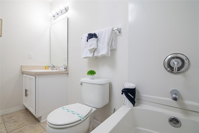 bathroom with a bath, vanity, tile patterned flooring, and toilet