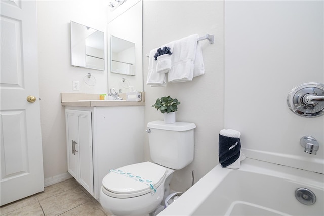 bathroom with a tub, vanity, toilet, and tile patterned floors