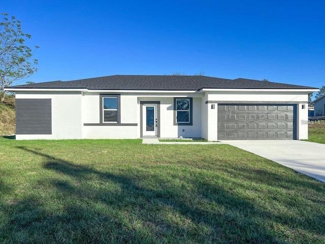 single story home featuring a garage and a front lawn