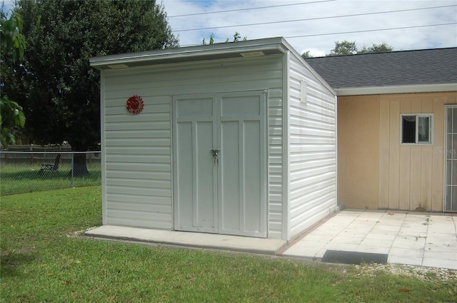 view of outdoor structure featuring a lawn