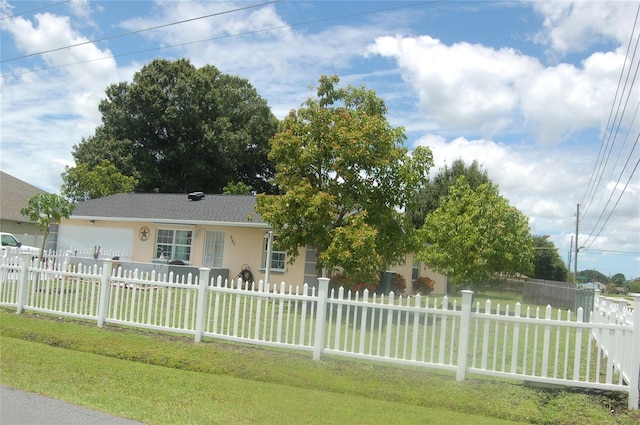 ranch-style house with a front yard and a garage