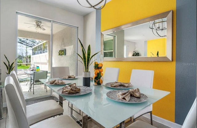 dining room with ceiling fan with notable chandelier