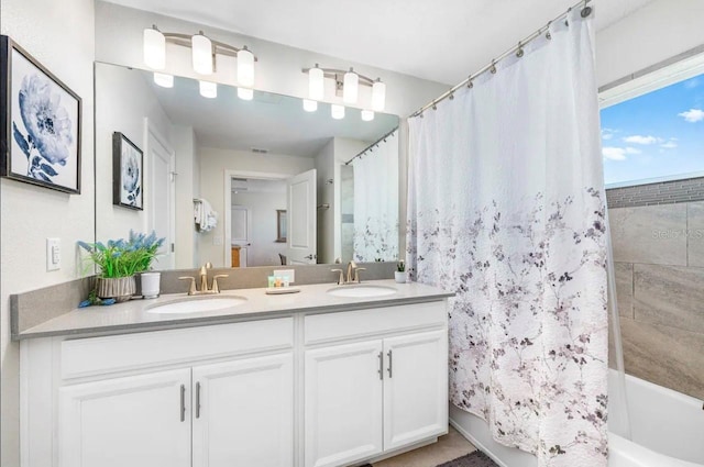 bathroom featuring double sink vanity and shower / bath combo