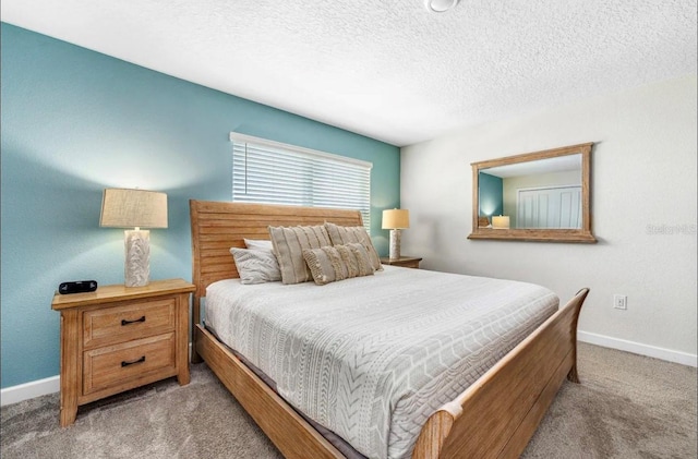 bedroom featuring carpet floors and a textured ceiling