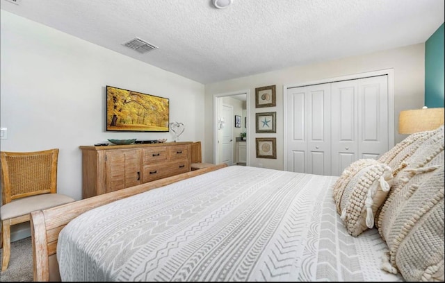 bedroom with a closet and a textured ceiling