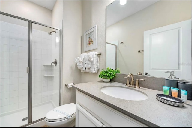 bathroom with vanity, walk in shower, and toilet