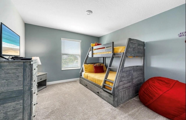 bedroom featuring a textured ceiling and carpet flooring