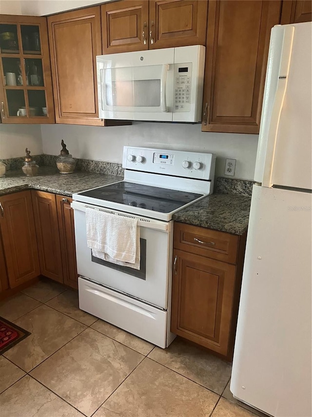 kitchen featuring white appliances and light tile patterned floors