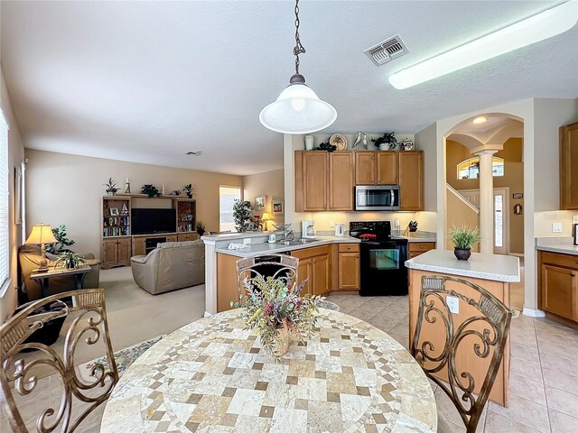 tiled dining area with sink and decorative columns