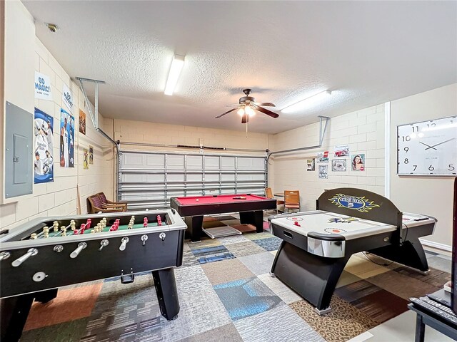 game room with ceiling fan, a textured ceiling, pool table, and electric panel