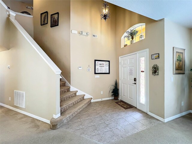 entrance foyer featuring a textured ceiling and light carpet