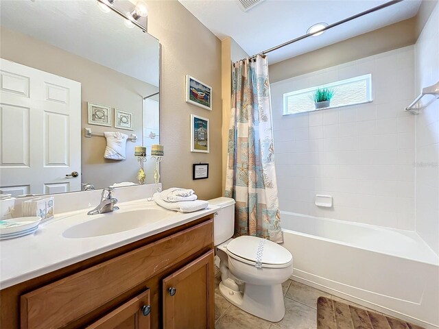 full bathroom featuring tile patterned floors, toilet, shower / bathtub combination with curtain, and vanity