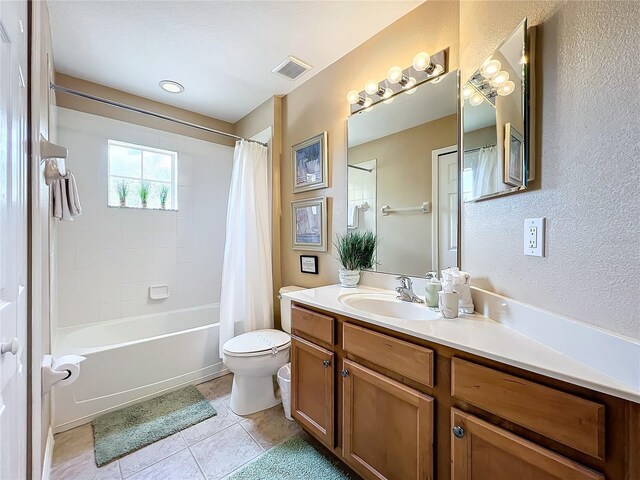 full bathroom featuring tile patterned flooring, toilet, vanity, and shower / tub combo