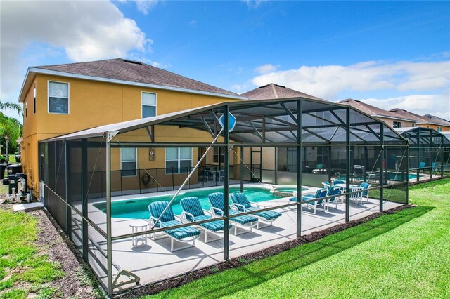 view of swimming pool featuring glass enclosure, a lawn, and a patio