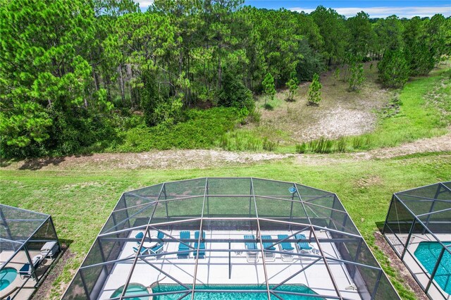 view of swimming pool with glass enclosure