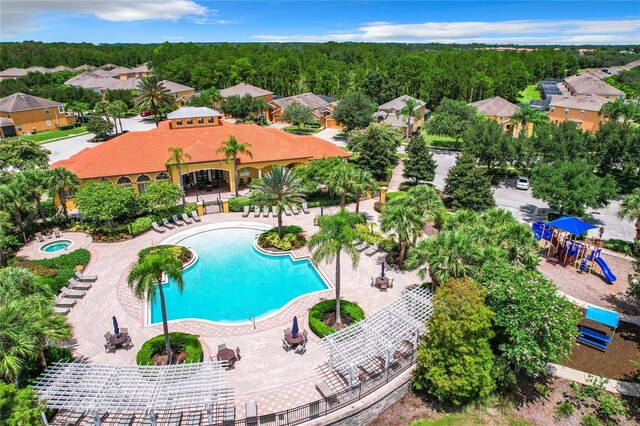 view of swimming pool with a patio and a playground