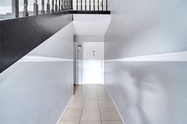 hallway featuring light tile patterned floors