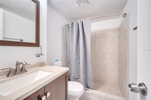 bathroom featuring vanity, a shower with shower curtain, and toilet