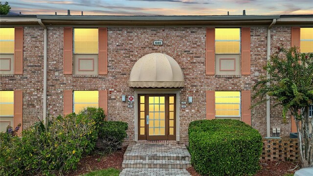 view of exterior entry at dusk