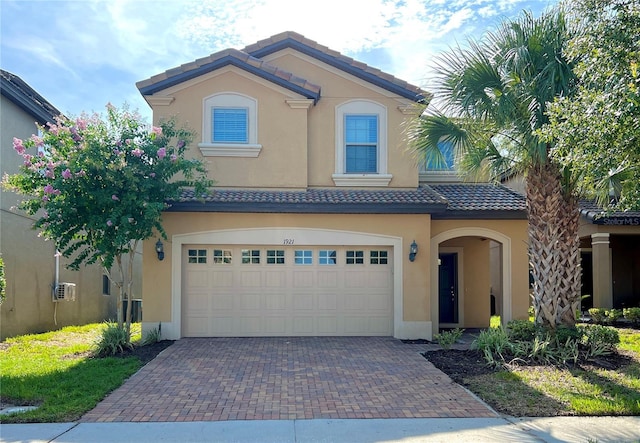 mediterranean / spanish-style home featuring a garage