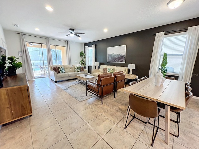 tiled living room featuring ceiling fan