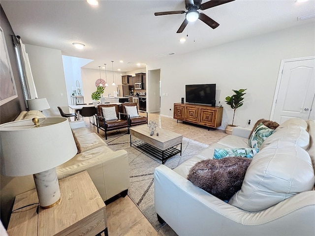 tiled living room featuring ceiling fan