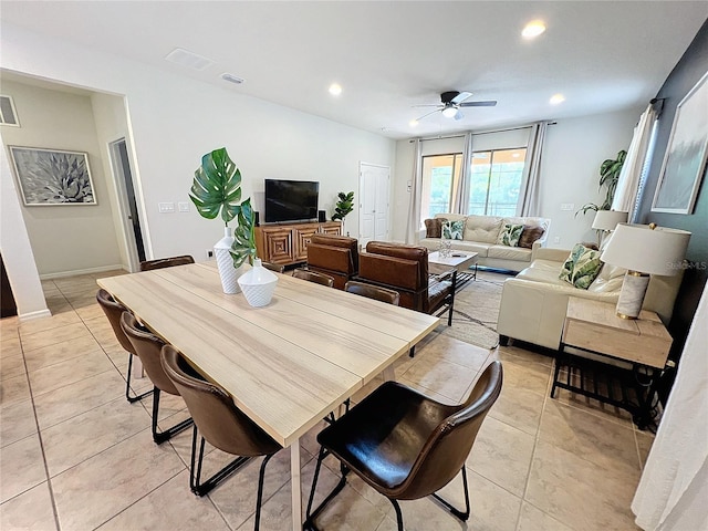 dining space with light tile patterned floors and ceiling fan