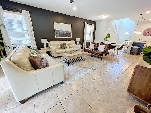 tiled living room with ceiling fan