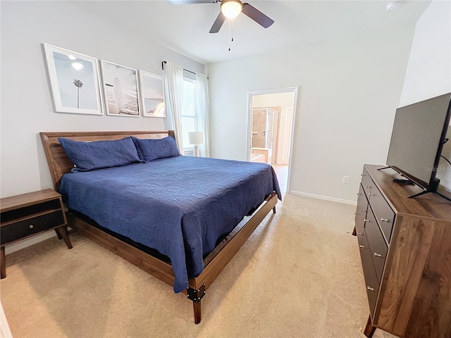 bedroom featuring light carpet, ceiling fan, and connected bathroom