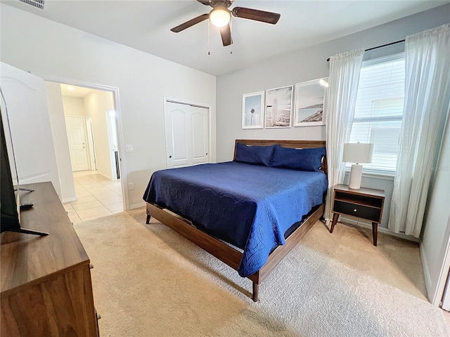 bedroom with light carpet and ceiling fan