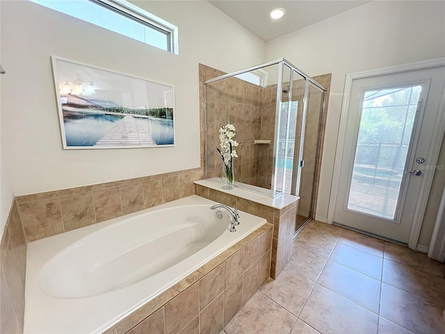 bathroom with separate shower and tub and tile patterned flooring