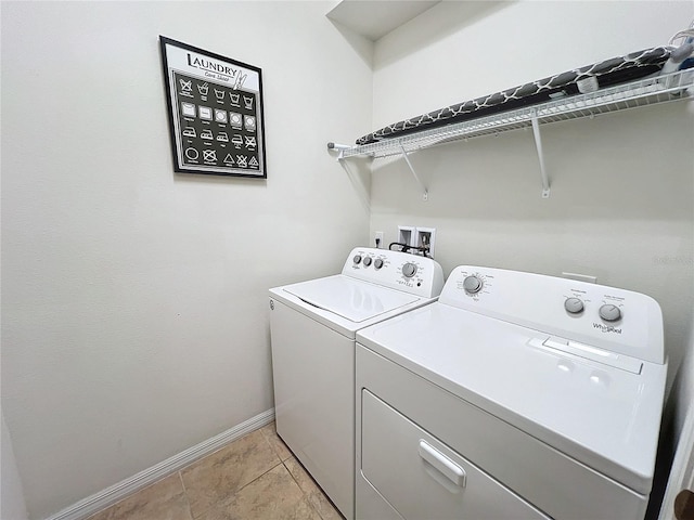 laundry room with washer and dryer and light tile patterned floors