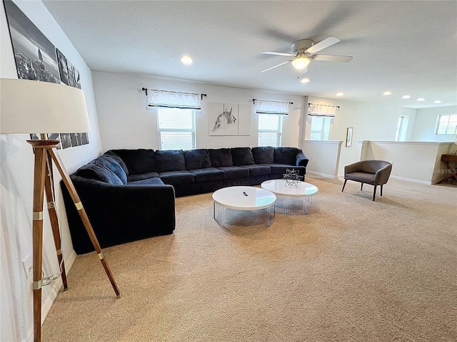 carpeted living room featuring ceiling fan