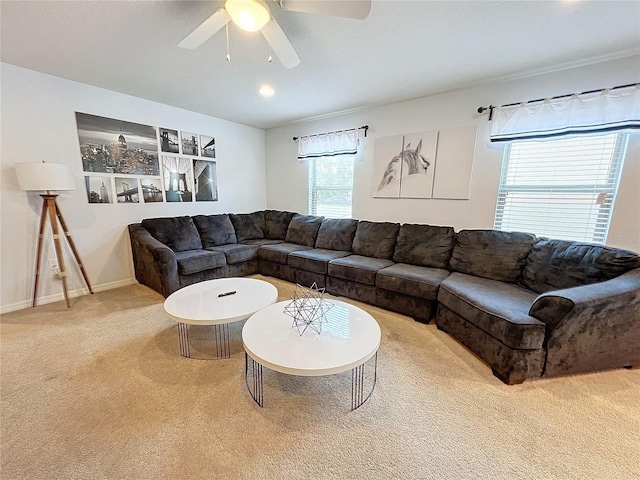 carpeted living room with ceiling fan