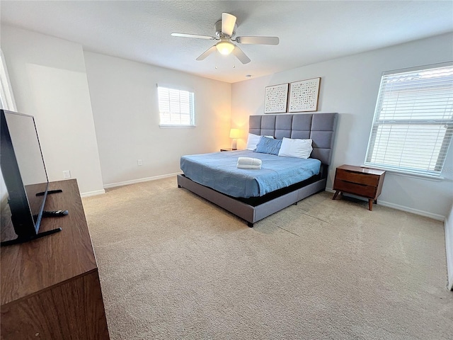 bedroom with light colored carpet and ceiling fan