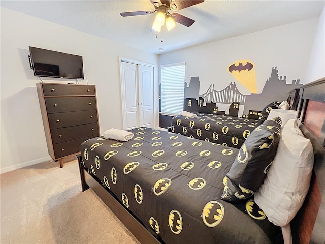 bedroom with ceiling fan, a closet, and light carpet