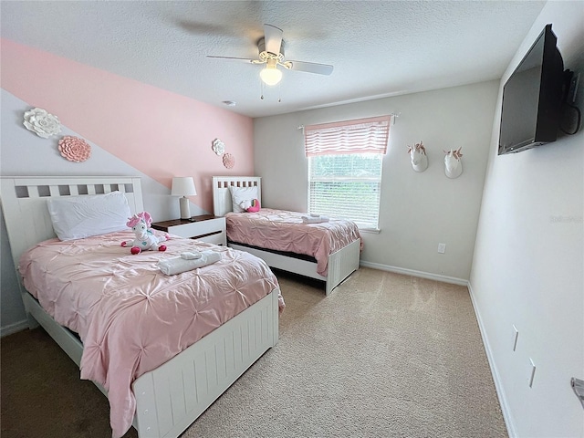 carpeted bedroom featuring a textured ceiling and ceiling fan